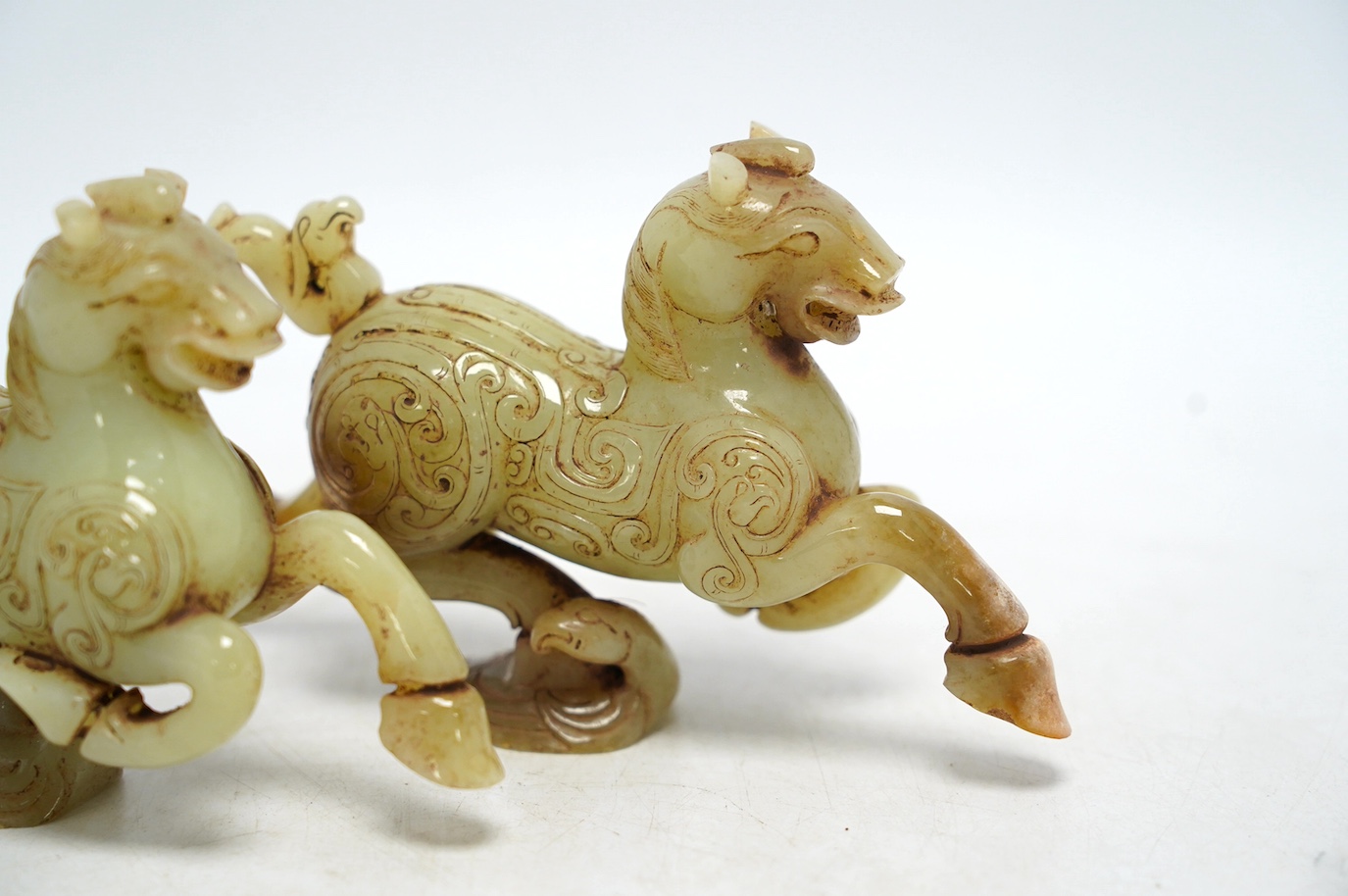 A pair of Chinese green jade horses, Han style, cased, 15cm wide. Condition - good